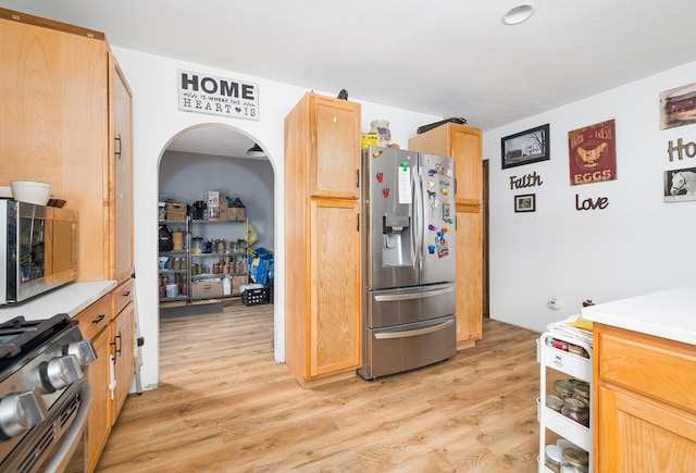 kitchen with light wood-type flooring and appliances with stainless steel finishes