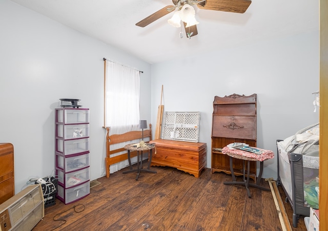 sitting room with dark hardwood / wood-style floors and ceiling fan