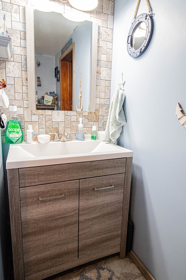 bathroom featuring vanity and tasteful backsplash