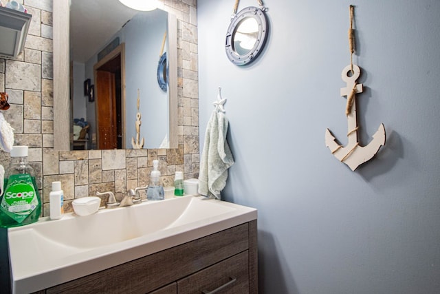 bathroom with vanity and tasteful backsplash