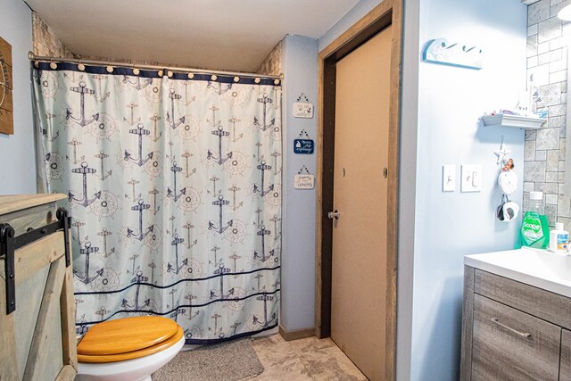 bathroom featuring toilet, vanity, and walk in shower