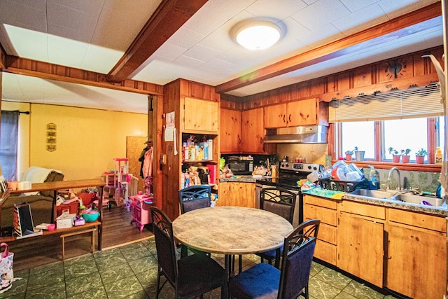 kitchen featuring sink, stainless steel electric range, and beamed ceiling