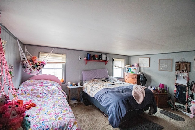 bedroom featuring carpet and multiple windows