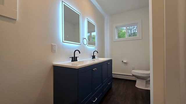 105 Taylor St, Blossburg, PA 16912 - bathroom featuring a baseboard radiator, toilet, double vanity, and wood finished floors