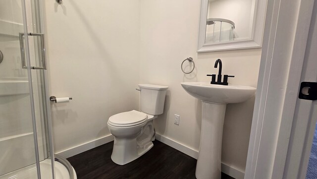 105 Taylor St, Blossburg, PA 16912 - bathroom featuring toilet, wood finished floors, a stall shower, baseboards, and a sink