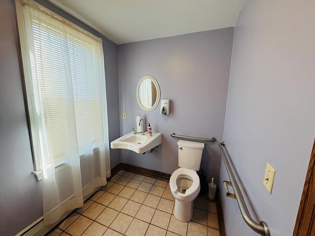 bathroom featuring toilet, sink, and tile patterned flooring