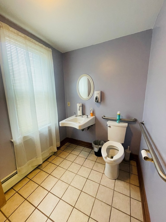 bathroom with tile patterned floors, sink, a baseboard radiator, and toilet