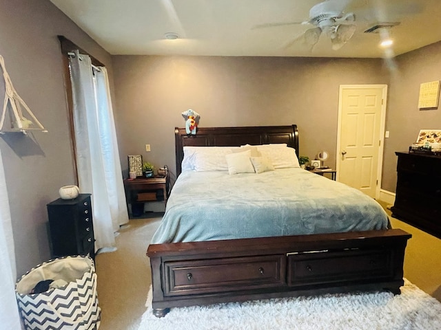 bedroom with ceiling fan and light colored carpet