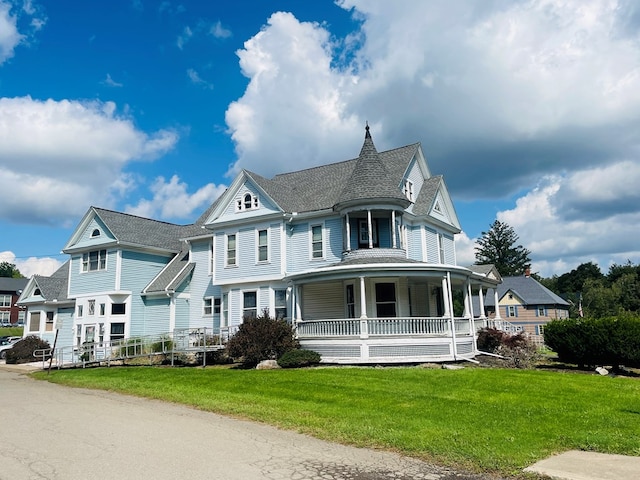 victorian-style house with a front lawn and covered porch