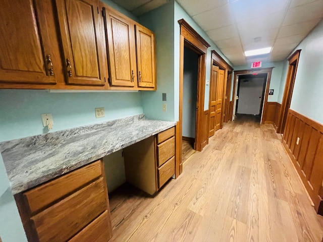 interior space with wooden walls and light hardwood / wood-style flooring