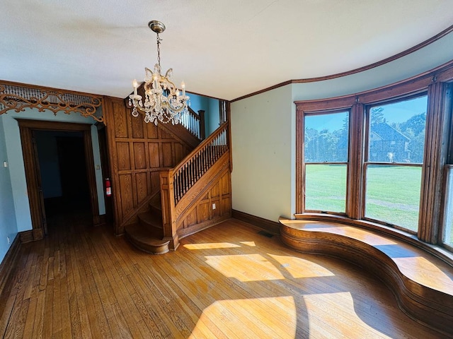 interior space with hardwood / wood-style floors, a wealth of natural light, and a chandelier