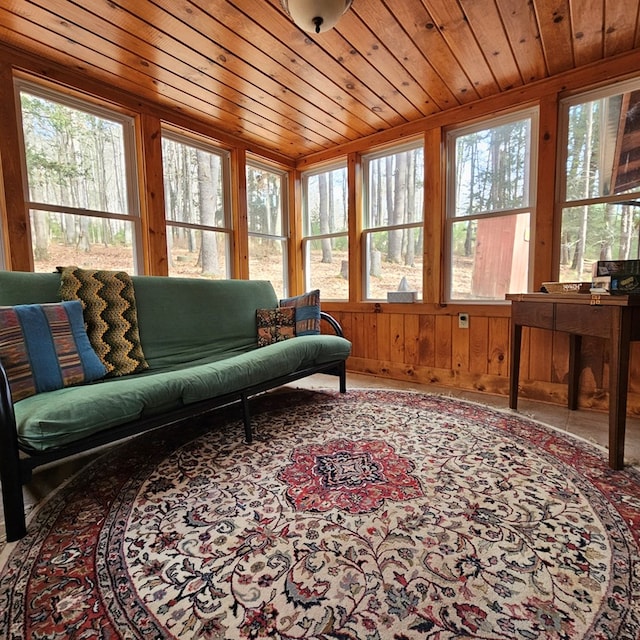 sunroom / solarium featuring wood ceiling and a healthy amount of sunlight