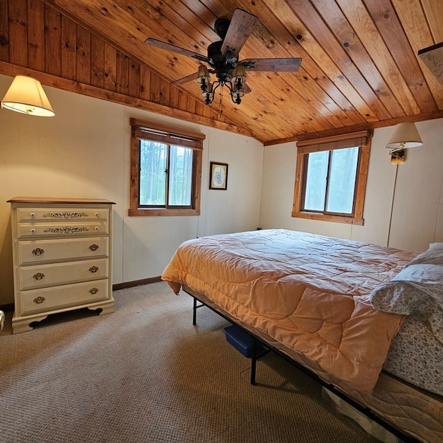 bedroom featuring lofted ceiling, multiple windows, wood ceiling, and carpet floors