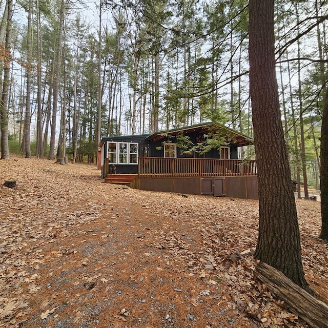 view of yard with a wooden deck and a sunroom