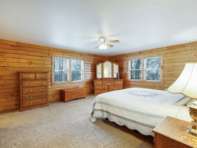 102 Fred Catlin Rd, Owego, NY 13827 - bedroom with carpet flooring, wood walls, and ceiling fan