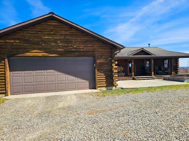 102 Fred Catlin Rd, Owego, NY 13827 - cabin featuring dirt driveway, an attached garage, log siding, and covered porch