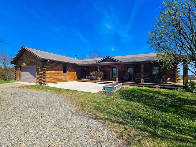 102 Fred Catlin Rd, Owego, NY 13827 - log cabin featuring an attached garage, driveway, log siding, and a front yard