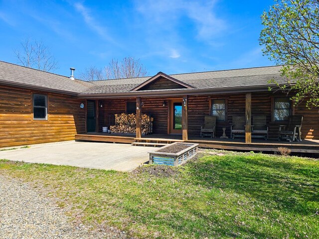 102 Fred Catlin Rd, Owego, NY 13827 - rear view of property featuring a porch, a lawn, roof with shingles, and faux log siding