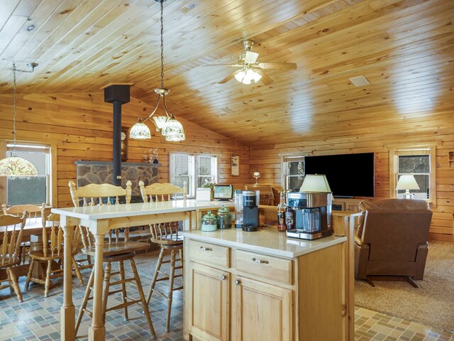 102 Fred Catlin Rd, Owego, NY 13827 - kitchen featuring lofted ceiling, wood walls, ceiling fan, brick floor, and a wood stove