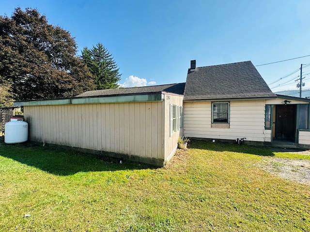 view of side of home featuring a yard