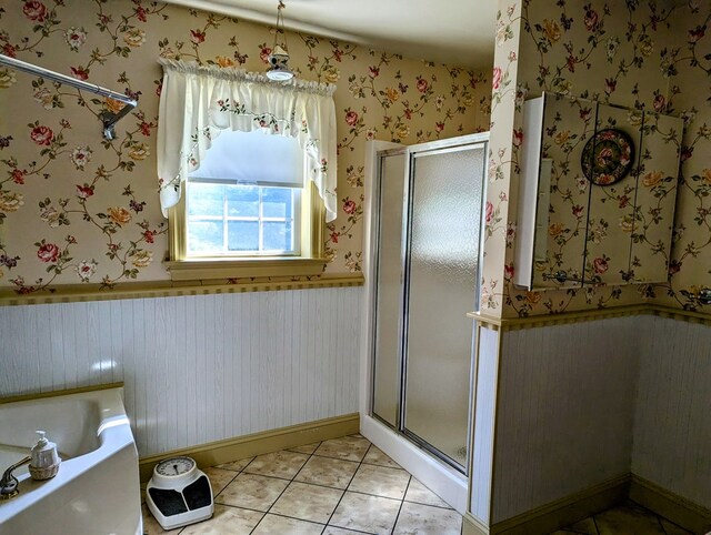 bathroom with separate shower and tub and tile patterned floors