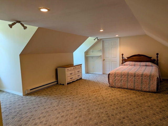 bedroom with baseboard heating, vaulted ceiling, and light carpet