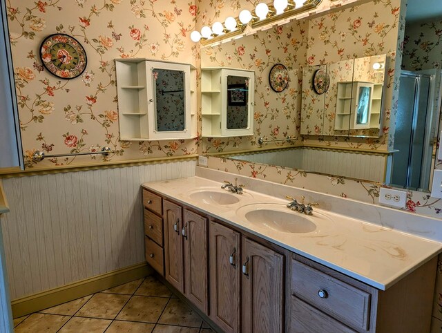 bathroom with tile patterned floors, a shower with shower door, and vanity