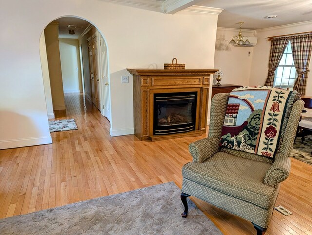 sitting room featuring light hardwood / wood-style flooring and ornamental molding