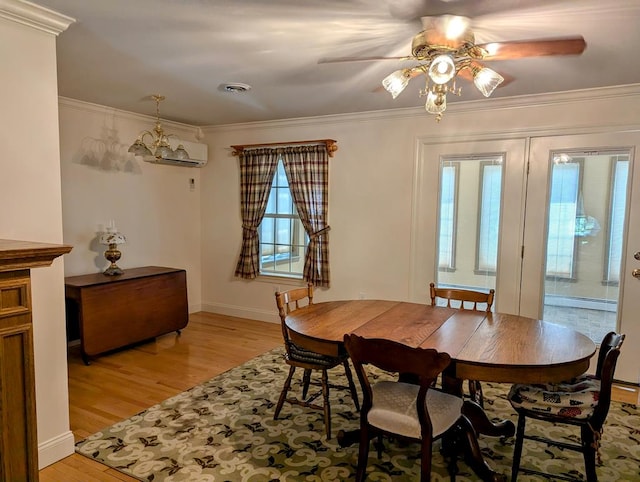 dining area with crown molding, ceiling fan with notable chandelier, and light wood-type flooring