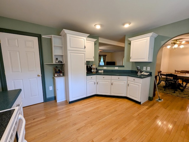 kitchen with white cabinets, light wood-type flooring, and electric stove