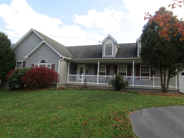 view of front of property with a porch, a garage, and a front yard