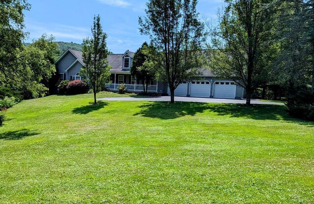 view of yard with a porch and a garage