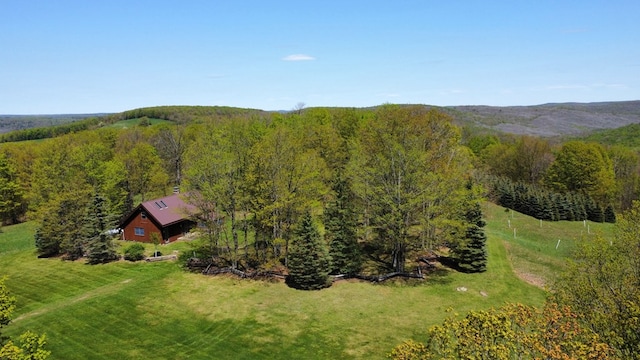 aerial view of property and surrounding area featuring a forest
