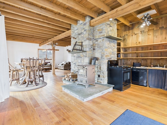 living room featuring wooden ceiling, a wood stove, ceiling fan, beam ceiling, and wood finished floors