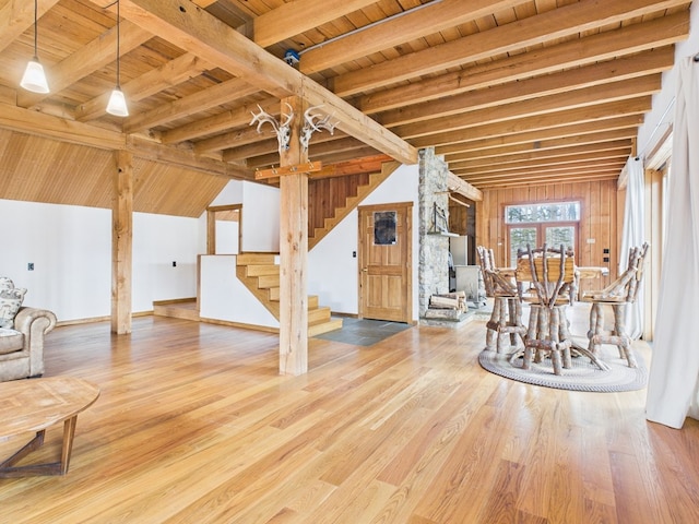 living area featuring wooden ceiling, stairway, beamed ceiling, and wood finished floors