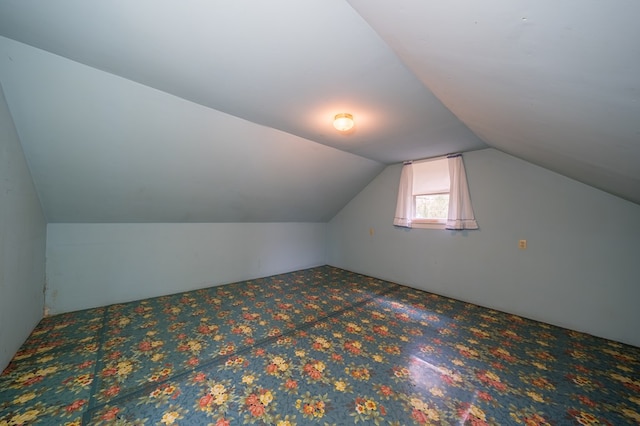 bonus room featuring lofted ceiling and carpet flooring