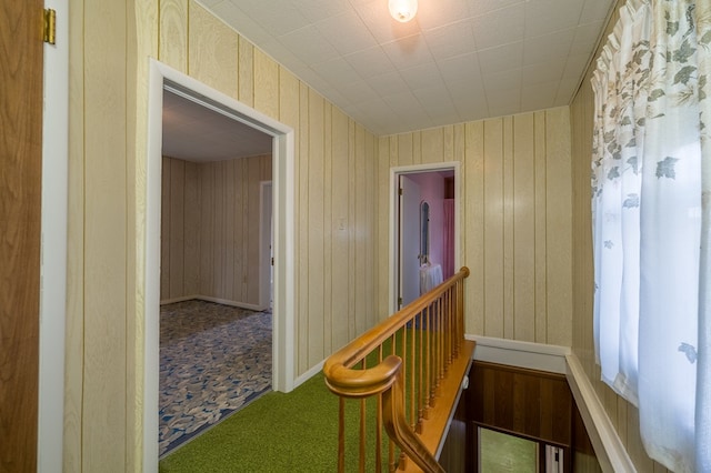 hallway featuring an upstairs landing