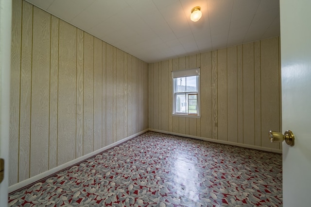 unfurnished room with baseboards