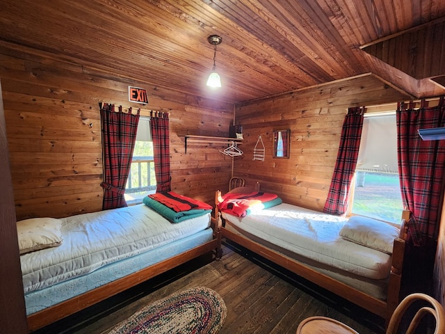 unfurnished bedroom with wood-type flooring, wood walls, and wood ceiling