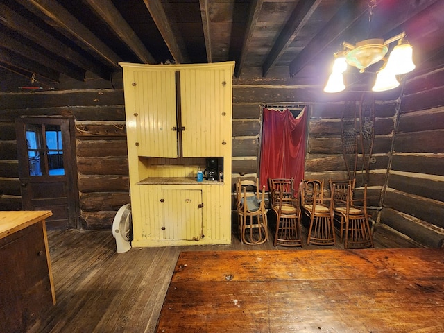 miscellaneous room featuring beam ceiling, dark hardwood / wood-style flooring, and rustic walls