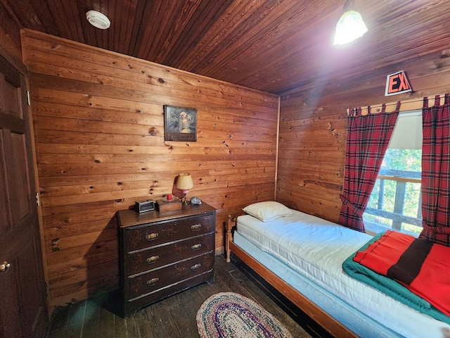 bedroom featuring wooden ceiling, dark hardwood / wood-style floors, and wooden walls