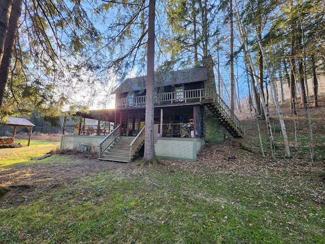 rear view of property with a lawn