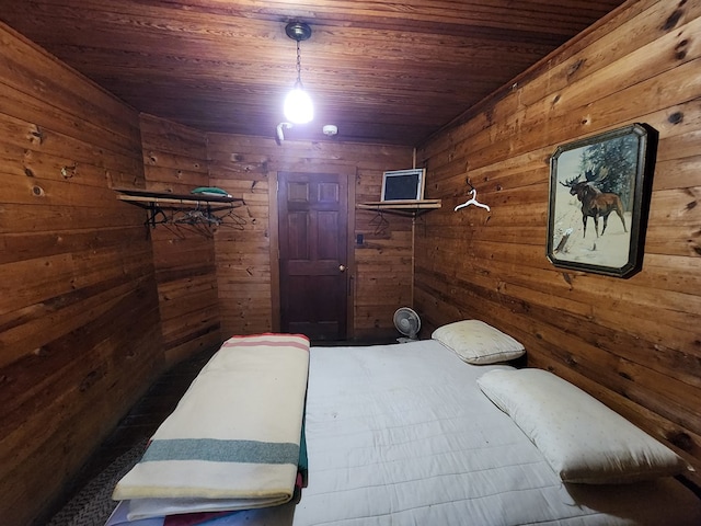 bedroom featuring wooden walls and wood ceiling