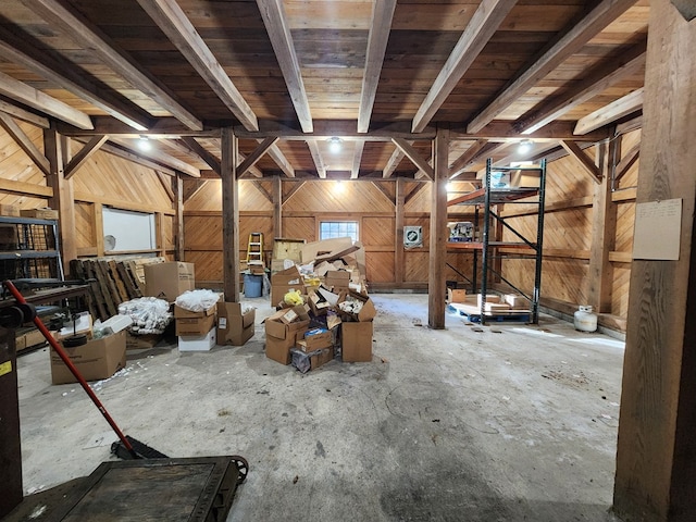 misc room featuring wood walls and beam ceiling