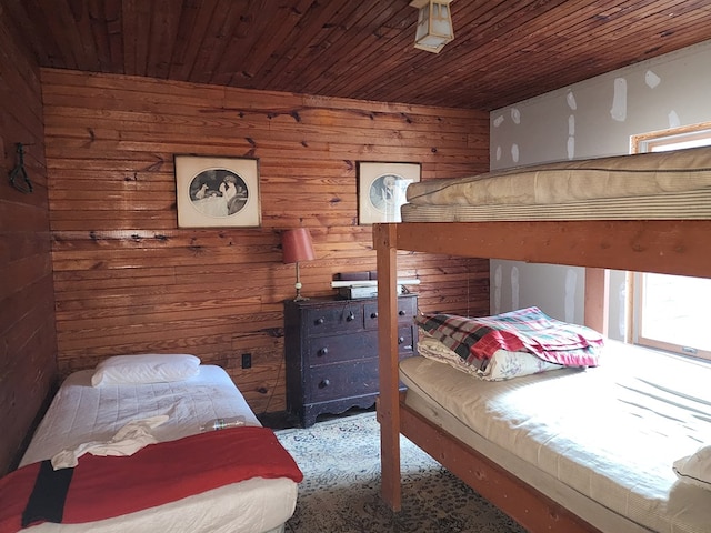 bedroom featuring wood ceiling and wooden walls