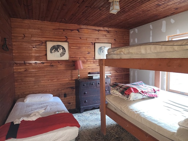 bedroom featuring wood ceiling and wooden walls