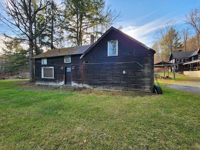 back of house with a lawn