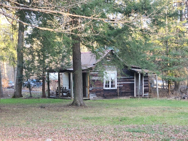 view of property hidden behind natural elements with a front lawn