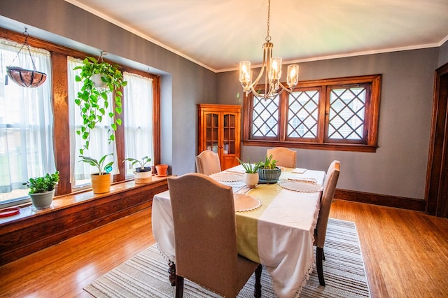 818 W Water St, Elmira, NY 14905 - dining room with wood finished floors, a chandelier, and crown molding