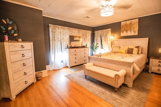 818 W Water St, Elmira, NY 14905 - bedroom with crown molding and light wood-style floors